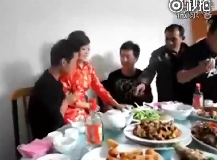 Nonsense scene on wedding in China: bride sits on male guests' lap