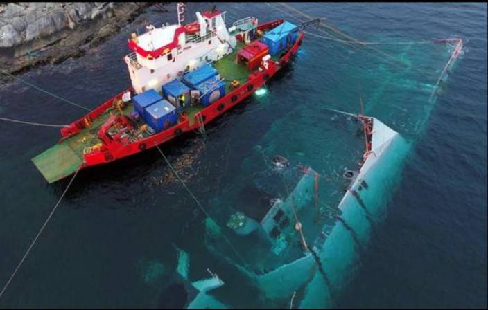 A crane barge is at the scene of the sinking of the frigate 